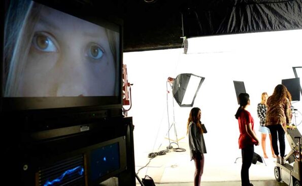 students with camera and projector and an actor