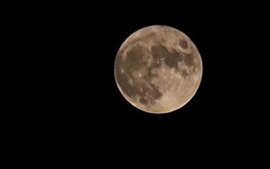 a full moon in the dark sky