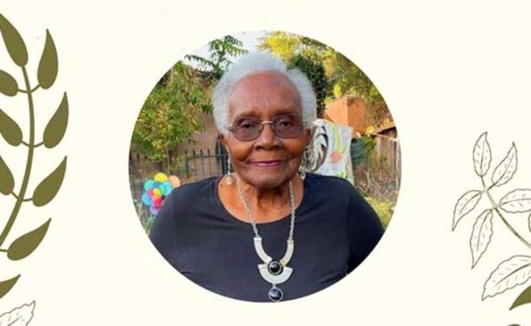 A woman with white hair and glasses