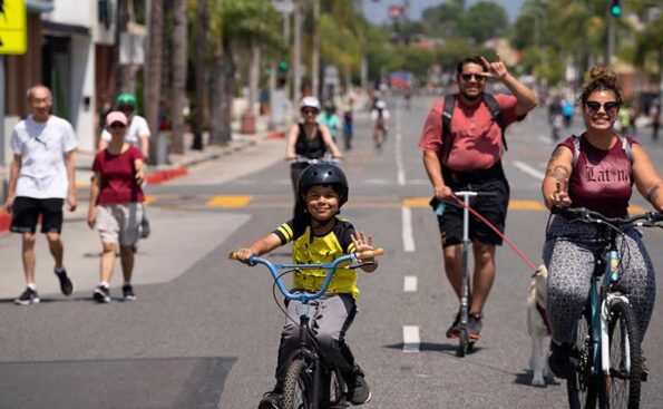 A family on scooters and bikes