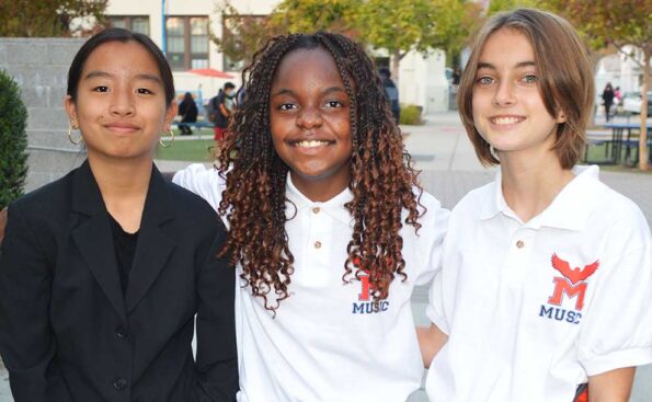Three students smiling