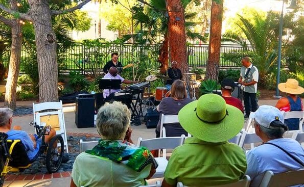 band playing with audience members wearing hats