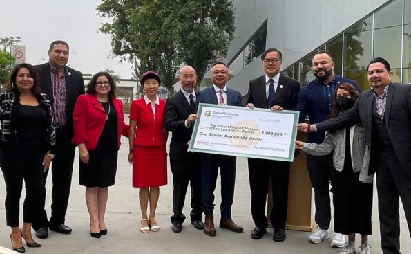A group of people holding an oversized check