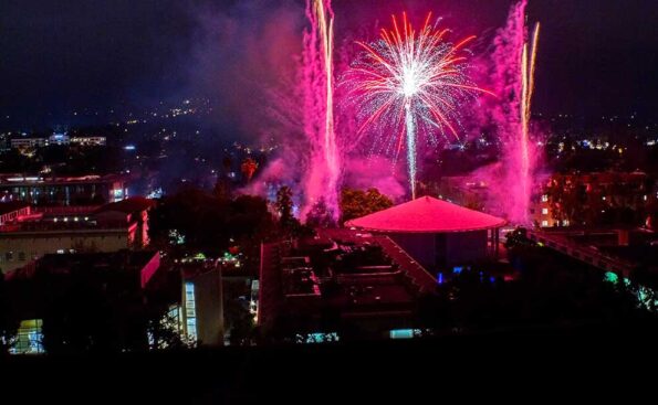 fireworks over a campus at night