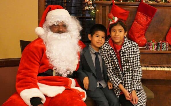 Santa and two kids next to him