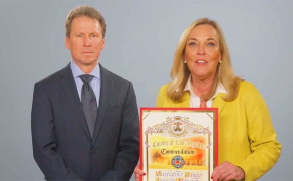 a man and a woman holding a certificate