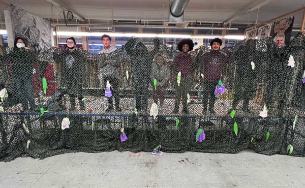 Students spreading a canopy