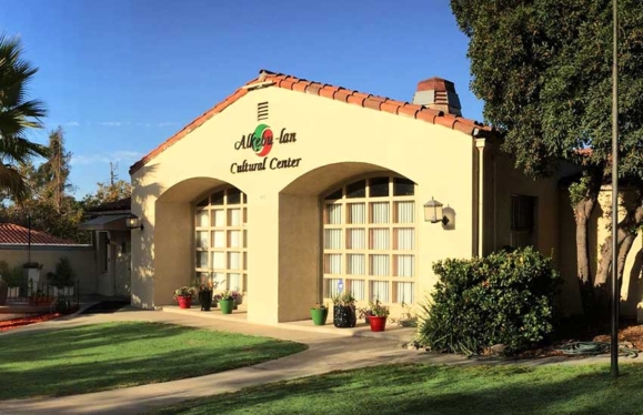 A building with a manicured lawn in front of it