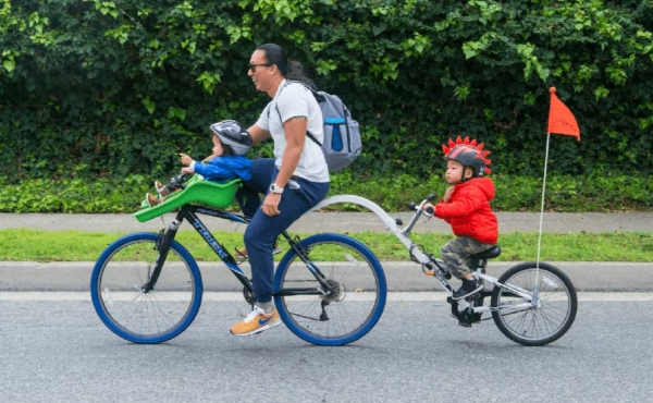 a mom and her child behind her on two separate bikes