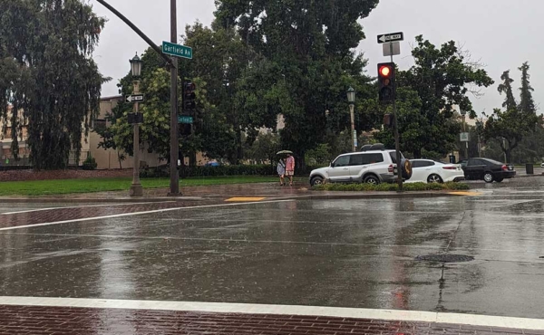 Man and woman walking under an umbrella