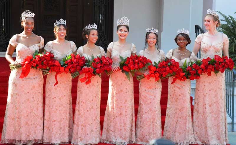 girls holding bouquets of flowers