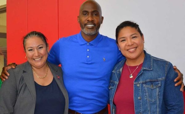 a man and two women smiling