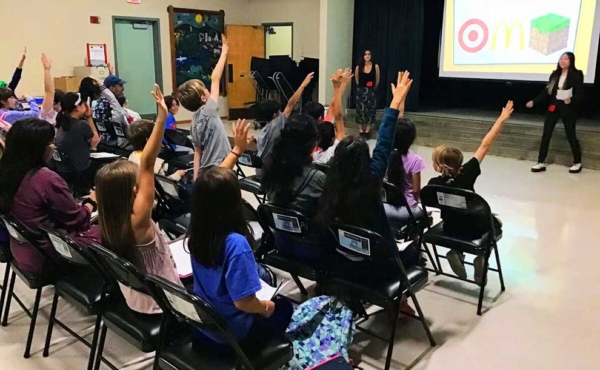 A high school student mentoring elementary students