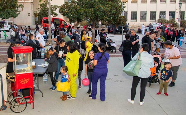 kids in Halloween costumes waiting in line for popcorn