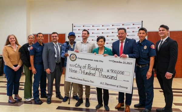 group of people holding an oversized check