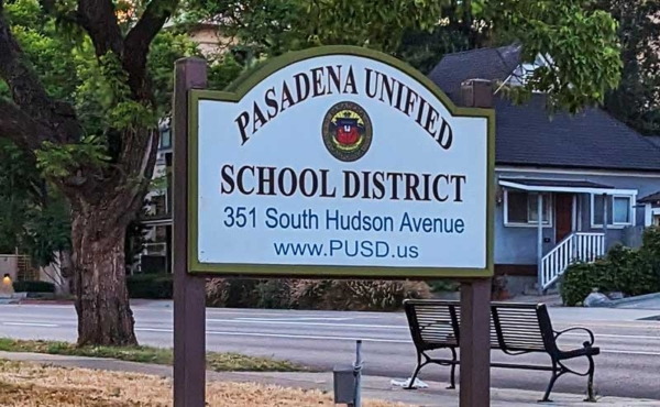 A sign on the street for a school district