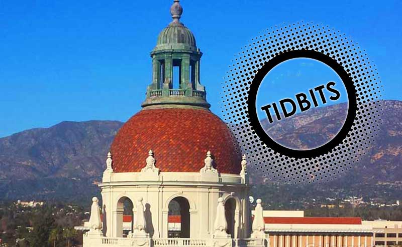 a dome of a building with mountains in the background