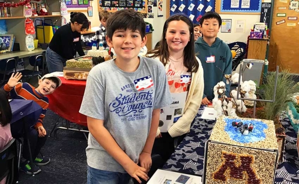 students in front of art projects