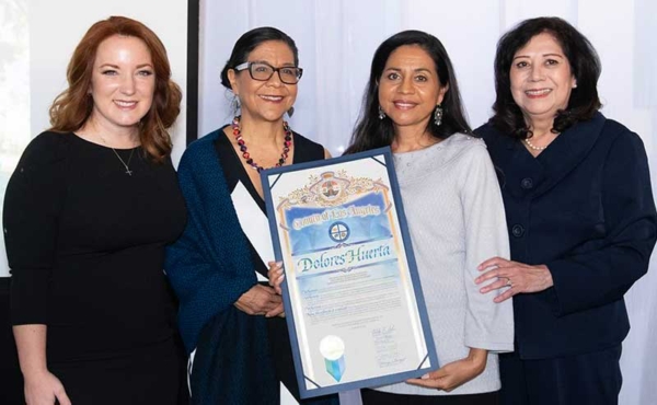 4 women holding an award