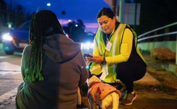 a volunteer talking to an unhoused person