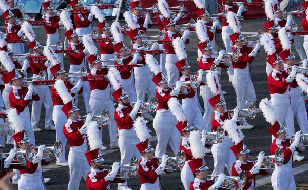 dressed in red and white, a local college band marches