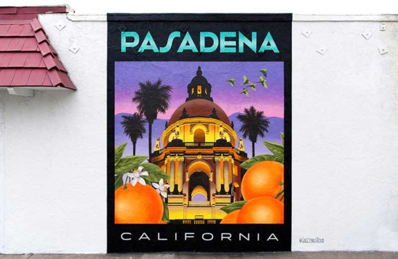 A mural on a wall depicting city hall and oranges