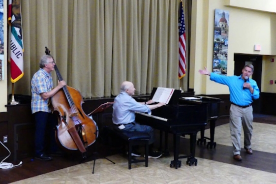 three men playing instruments and singing