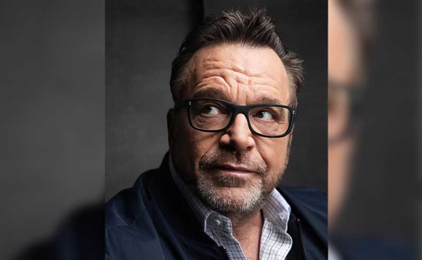 A man wearing glasses looking upward