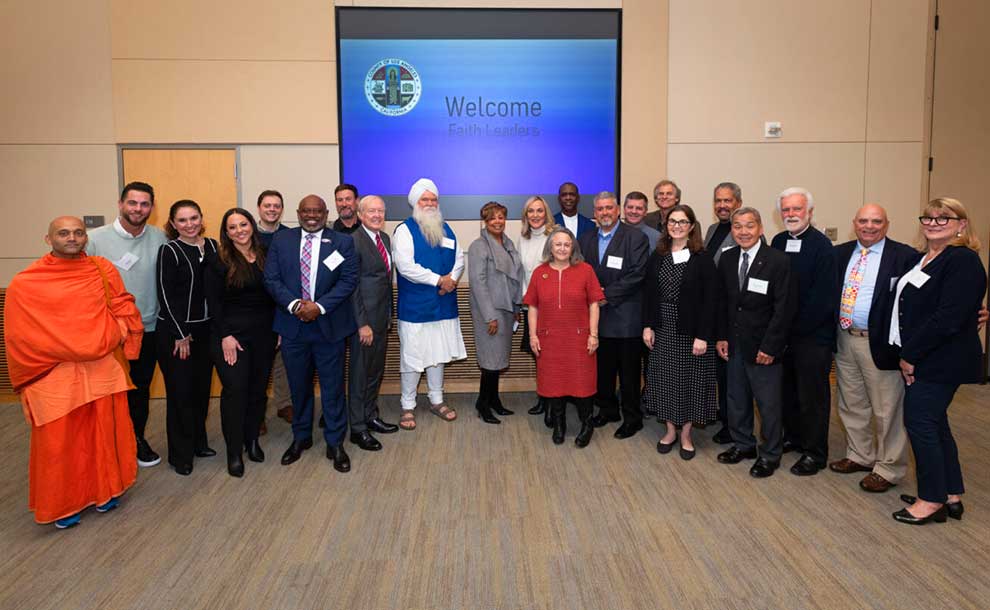 A group of faith leaders gather around a politician