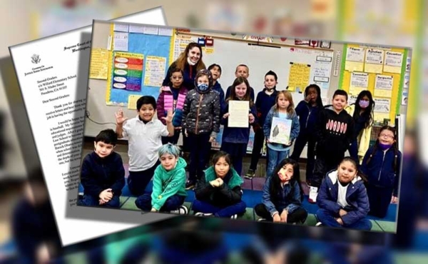 students pose for a photo with their teacher