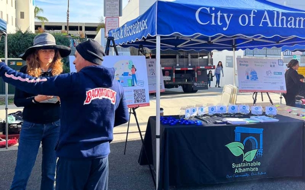 a man talking to a woman and a booth next to them