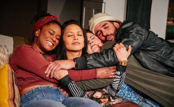 3 women and one guy cuddling and hugging each other