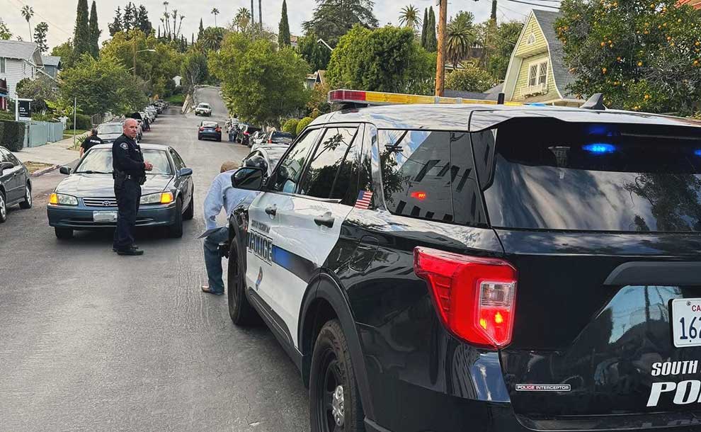 a police car blocking a road