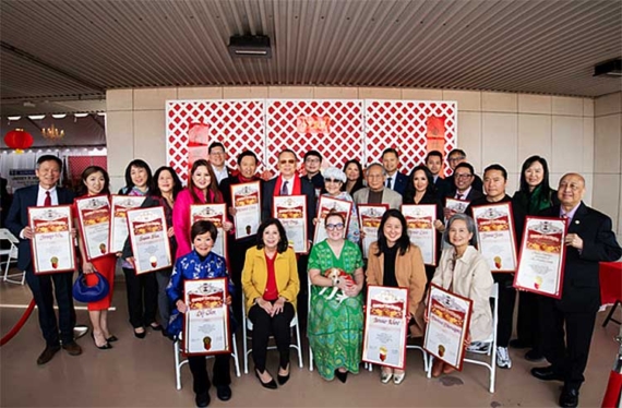 A group of people gather for a commemorative photo