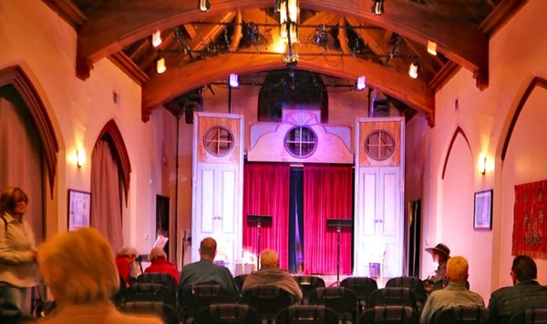 a theatre with audience waiting for a show