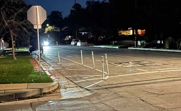 a cross street with spikes near a median