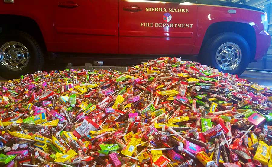 A firefighter truck near a pile of candy