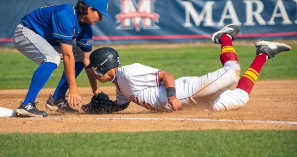 a baseball player sliding on the field