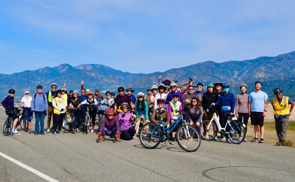 a group of cyclists pose for a photo