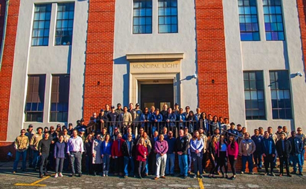 A group of employees in front of their company building