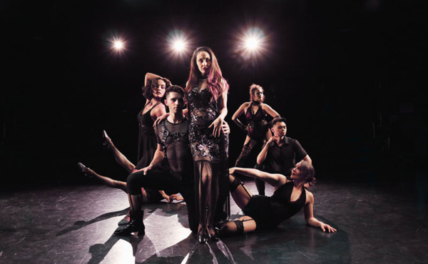 dancers with lights behind them