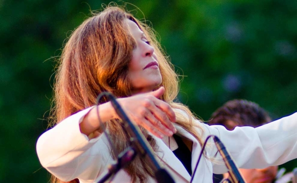 a woman conduct an orchestra