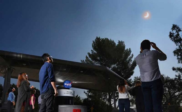 People looking up at an eclipse