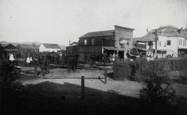 A black and white historical photo of a burned building