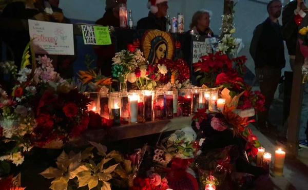 candles and flowers at a bus stop