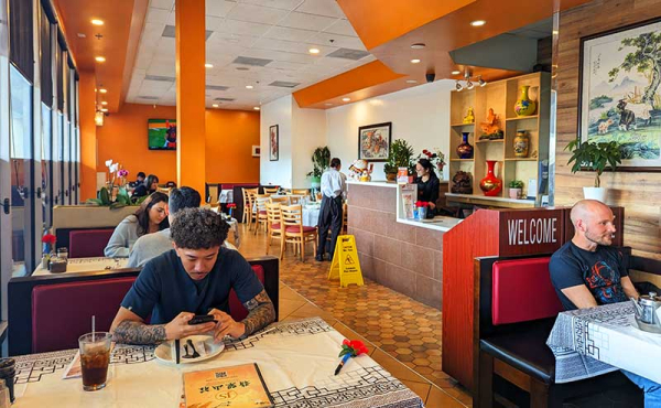 an interior of a restaurant with people eating