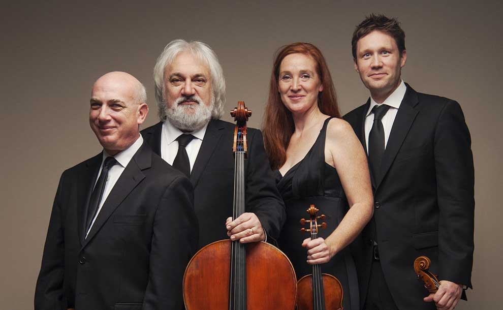 four musicians posing