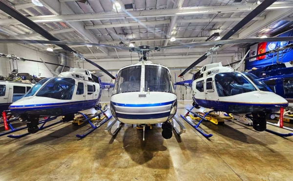 three helicopters in a hanger