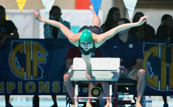 A girl diving into a pool