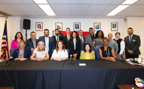 A group of men and women smiling